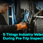 An image depicting an experienced industry professional conducting a thorough pre-trip inspection on a commercial vehicle, checking various components for safety and compliance